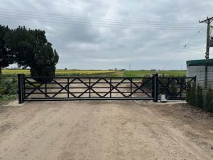 Automated black steel farm entrance gate installed at Moulton Chapel by Security Gates and Doors